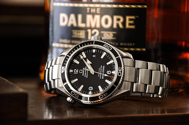 Omega watch with Dalmore Scotch Whisky stock photo