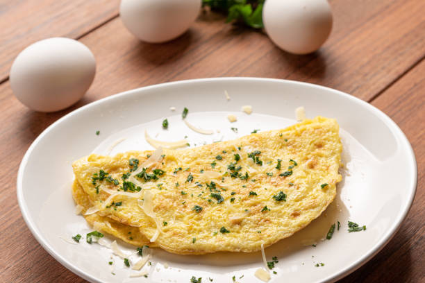 Omelet with parsley and cheese for breakfast on wooden background. stock photo