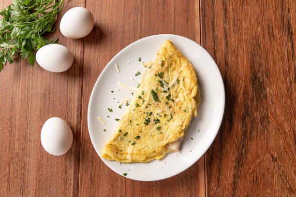 Omelet with parsley and cheese for breakfast on wooden background. stock photo