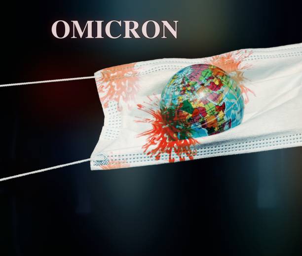 Omicron Globe sphere inside a surgical mask with the cells virus of omicron , new variant virus , In a black background. omicron stock pictures, royalty-free photos & images