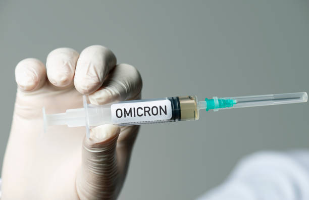 Omicron Variant Male doctor holding Coronavirus vaccine. The Omicron variant is a variant of SARS-CoV-2, the virus that causes COVID-19. omicron stock pictures, royalty-free photos & images