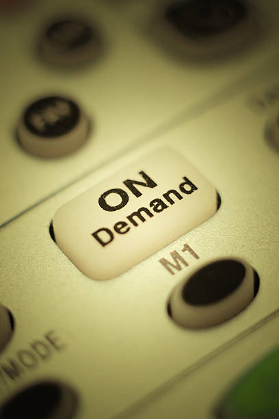 On Demand Button: Close Up Photo of Television Remote Control Extreme closeup of the "on demand" button on a cable television remote control. Concept photo for video-on-demand or pay-per-view. video on demand stock pictures, royalty-free photos & images