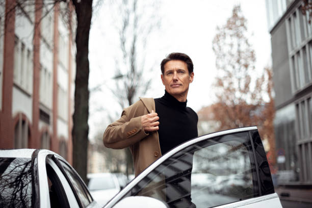 On the right place Handsome man is getting out of the car. georgijevic frankfurt stock pictures, royalty-free photos & images
