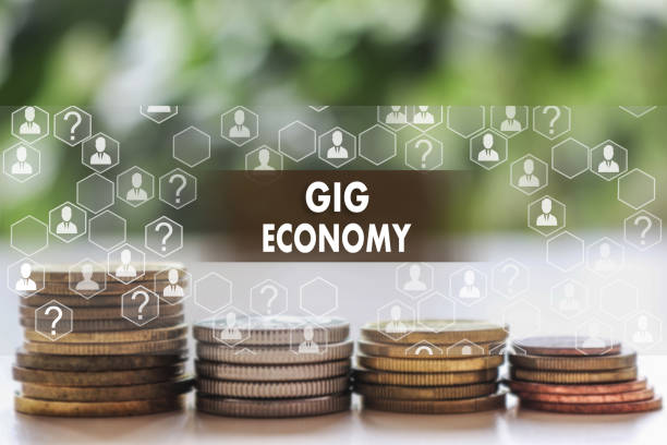 GIG ECONOMY on the touch screen with a  blur financial background .The concept GIG ECONOMY stock photo