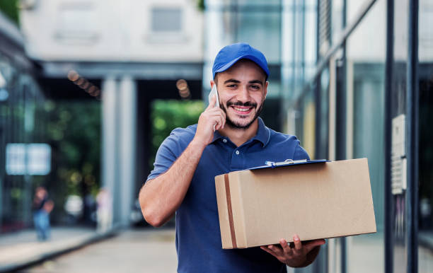On time. Courier delivering package stock photo