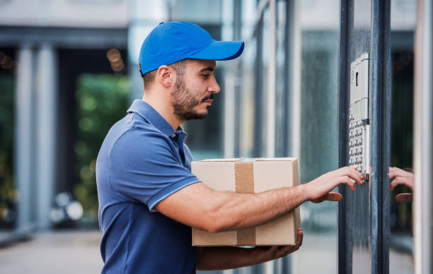 On time. Courier delivering package stock photo