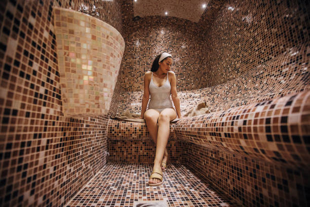 One beautiful woman relaxing in the steam room Beautiful young woman relaxing in the steam room at the spa center. turkish bath photos stock pictures, royalty-free photos & images