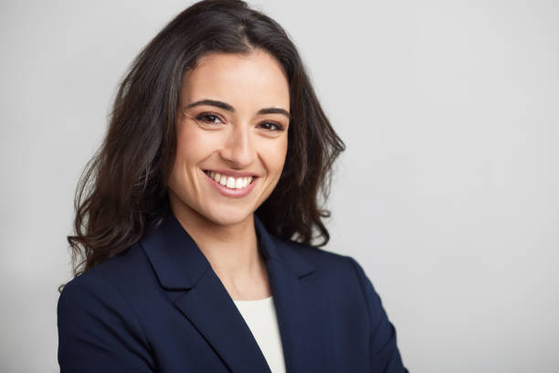 One businesswoman headshot smiling at the camera. stock photo