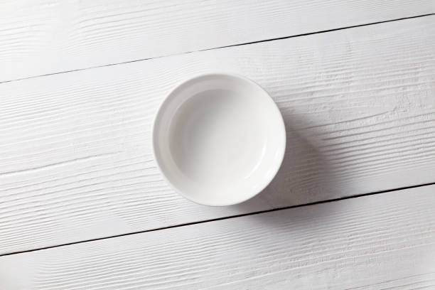 One empty plate on a white wooden kitchen table. Top view stock photo