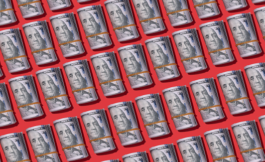One hundred dollar rolls isolated on red background