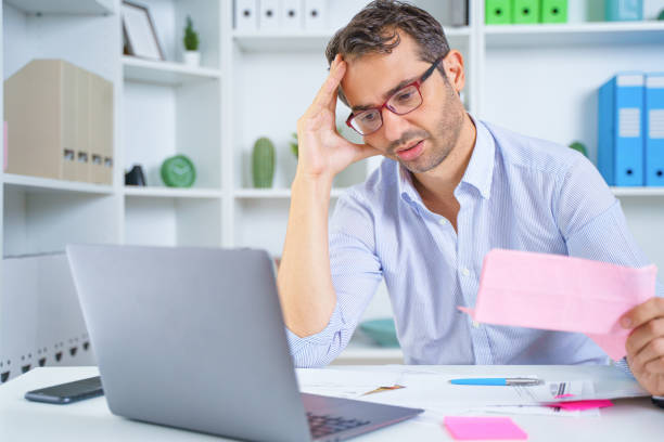 One man portrait frustrated by debt or bankruptcy managing household budget stock photo