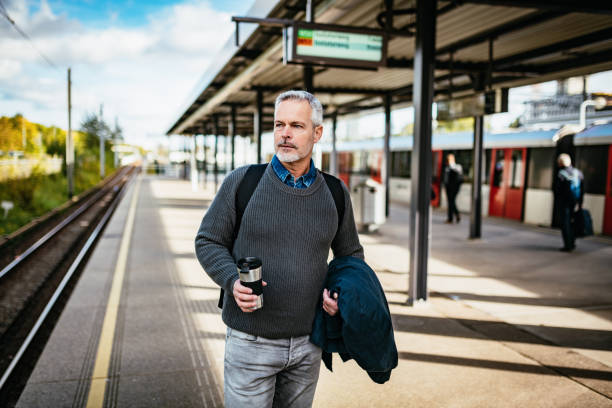 één mens die op de trein wacht terwijl het woon-werkverkeer tijdens covid-19 lockdown - pensioen nederland stockfoto's en -beelden