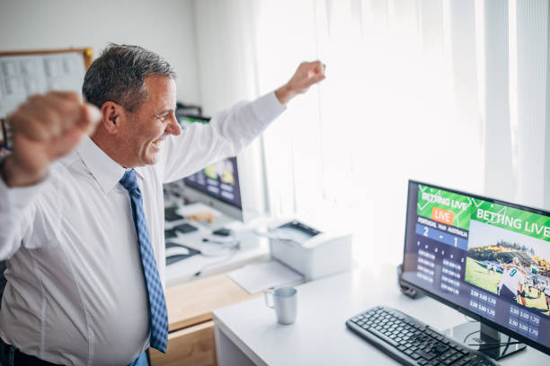 One senior business man live betting One senior business man live betting in his home office and winning sport betting stock pictures, royalty-free photos & images
