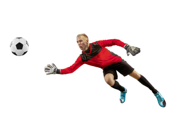 One soccer player goalkeeper man catching ball Male soccer player goalkeeper catching ball in jump. Silhouette of fit man with ball isolated on white studio background goalie stock pictures, royalty-free photos & images