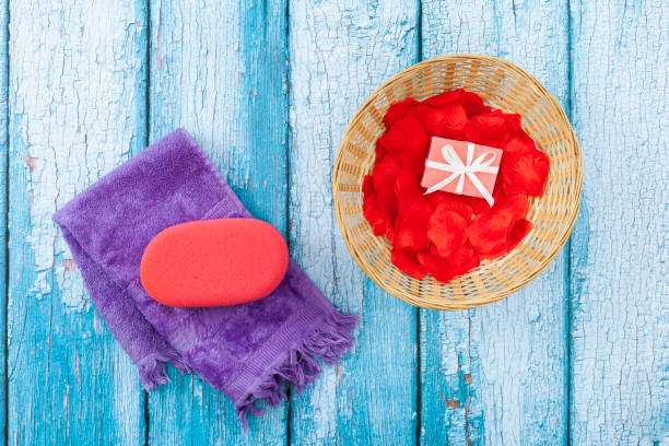 One towel, one sponge and one basket with soap stock photo