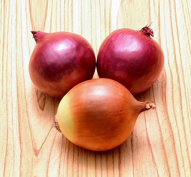 Onion on wooden background in studio