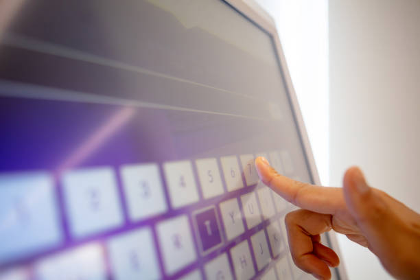 Online check-in Close-up of woman using touch screen monitor to check-in online self service photos stock pictures, royalty-free photos & images