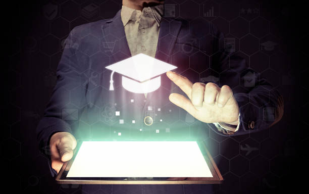 Online education concept Image of a man with a tablet in his hands. He presses on the icon graduation hat cap. Online education concept, choose of career. online degrees stock pictures, royalty-free photos & images