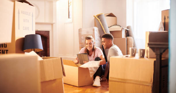 online house insurance young couple in their new house unpacking stock pictures, royalty-free photos & images