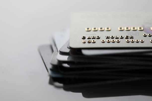 Online money for payment Close-up of plastic credit cards stack on reflecting black desk. Macro shot of domestic electronic unlimited finance. Commerce budget and management concept pile of credit cards stock pictures, royalty-free photos & images