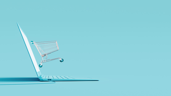 Online shopping concept. Laptop and shopping cart on blue background 3D Rendering