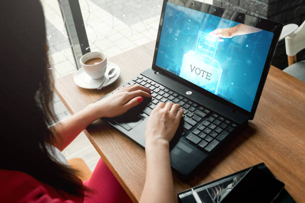 Online voting, hologram ballot and Internet voting box in laptop. Mixed environment, e-voting technology concept, internet elections. stock photo