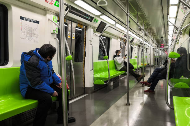 Only a few passengers with face masks travel in a empty subway train during coronavirus crisis in Beijing stock photo