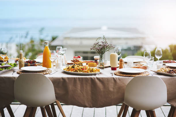 Only bring an empty stomach, we'll handle the rest Shot of a beautiful table setting outdoors dinner party stock pictures, royalty-free photos & images