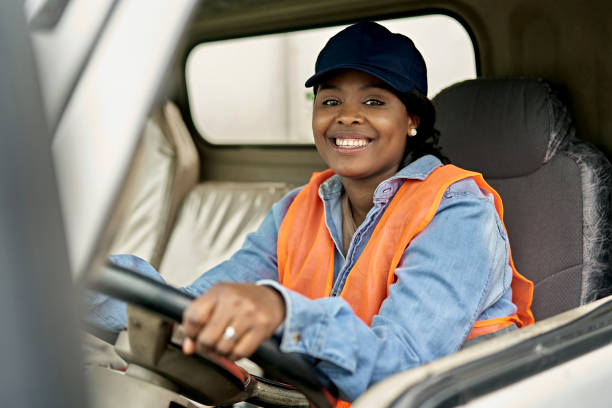 On-The-Job Portrait of Black Female Trucker in Cab stock photo