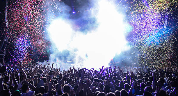 Open air party in the nighclub Live music event with lots of light, smoke and confetti rock musician stock pictures, royalty-free photos & images