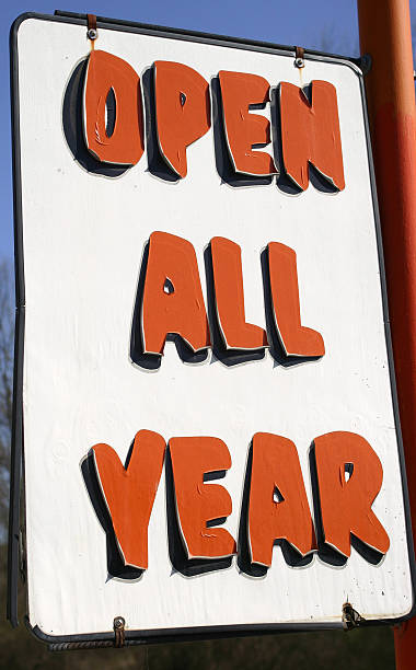 "open all year" sign at hot dog stand stock photo
