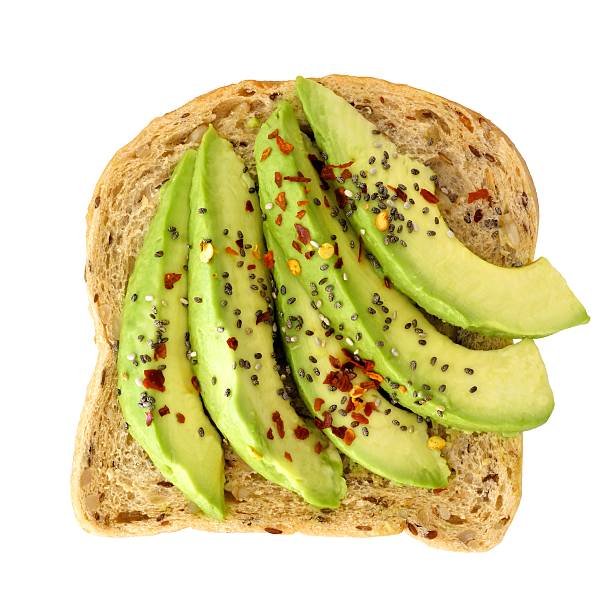 Open avocado sandwich with chia seeds isolated over white Open avocado sandwich with chia seeds and seasoning on whole grain bread isolated on a white background toasted bread stock pictures, royalty-free photos & images