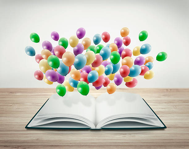 open book with balloons stock photo