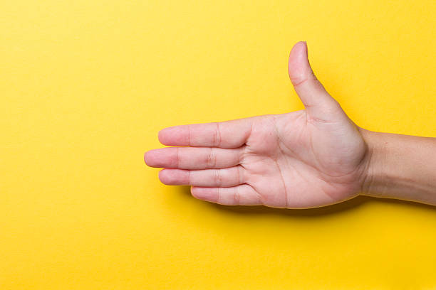 Open hand on a yellow background XXXL stock photo