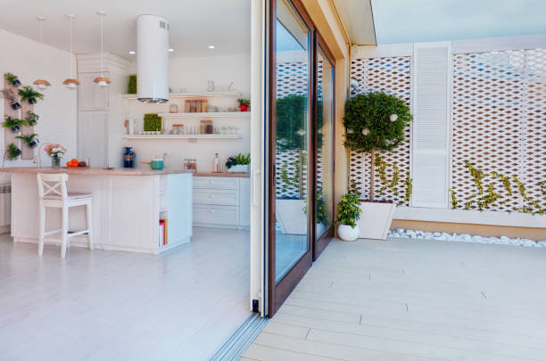 open space kitchen with sliding doors and rooftop patio zone stock photo