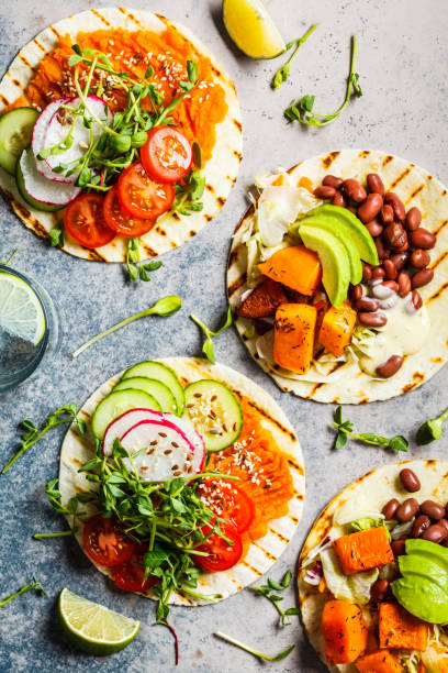 open vegan tortilla wraps with sweet potato, beans, avocado, tomatoes, pumpkin and  sprouts on gray background, flat lay. healthy vegan food concept. - plant based food imagens e fotografias de stock