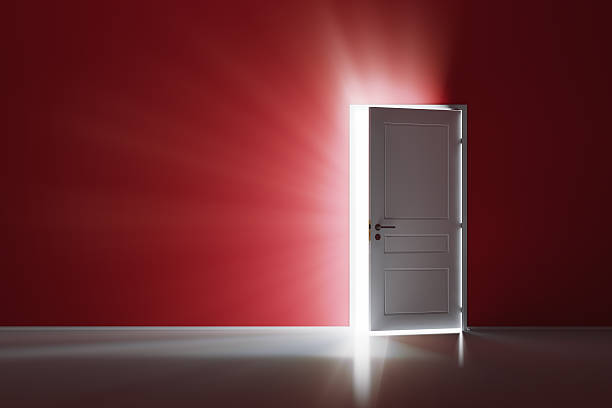 Open white door on red wall Rays of light through the open white door on red wall open door stock pictures, royalty-free photos & images