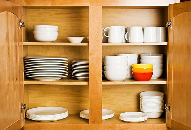 Open wood cupboard shelving plates dishes and jugs stock photo