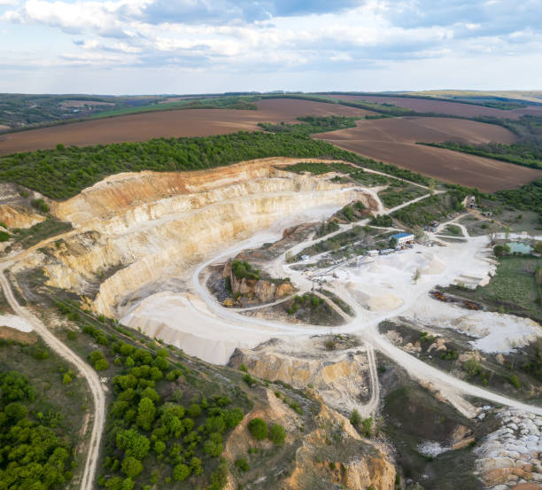 Opencast mining quarry with machinery at work stock photo