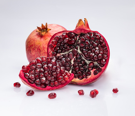 Opened ripe pomegranate on a white background