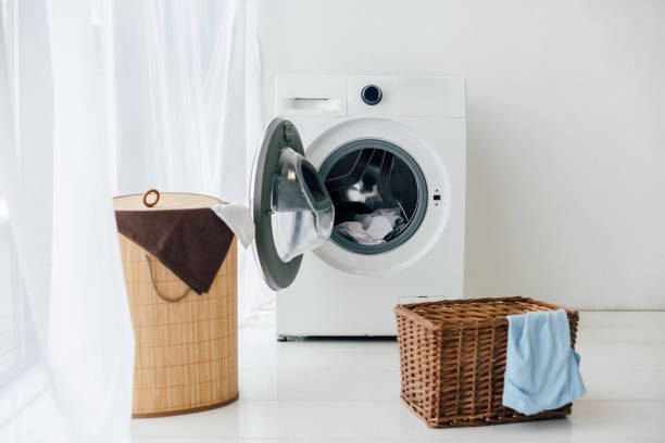 opened washer and brown baskets in laundry room opened washer and brown baskets in laundry room utility room photos stock pictures, royalty-free photos & images