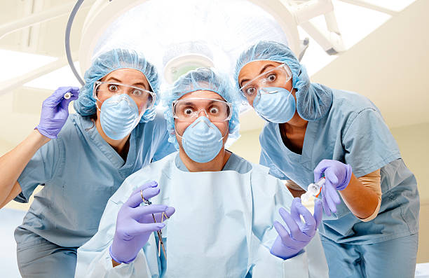 Operating Room Surgery Wide-eyed surgery team in operating room. mistake photos stock pictures, royalty-free photos & images