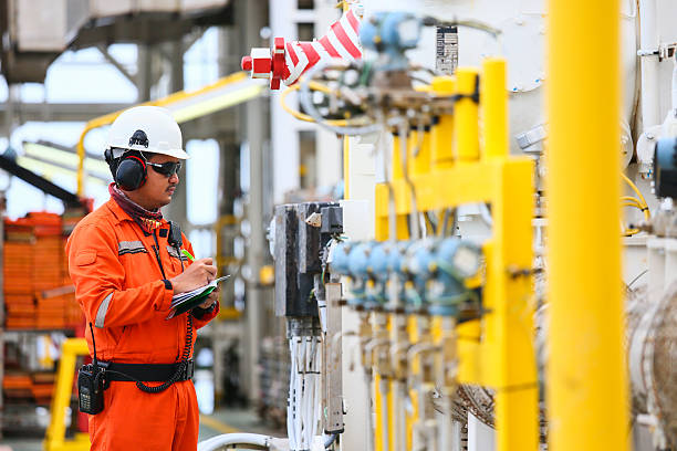 operator recording operation of oil and gas process operator recording operation of oil and gas process at oil and rig plant, offshore oil and gas industry, offshore oil and rig in the sea, operator monitor production process, routine daily record. crude oil stock pictures, royalty-free photos & images