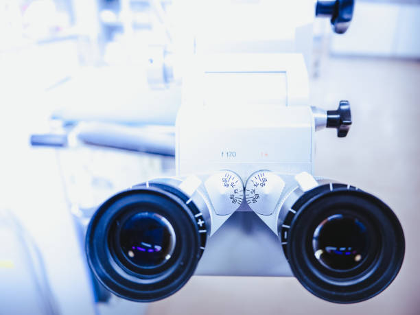 Optical viewfinder microscope for the operation of small cells in the eyes for treatment of diseases in hospital operating room stock photo