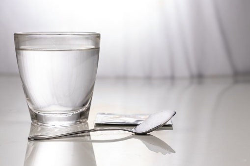 Ors Or Oral Rehydration Salt With Glass Of Water Sachet And Spoon Stock Photo - Download Image Now - iStock
