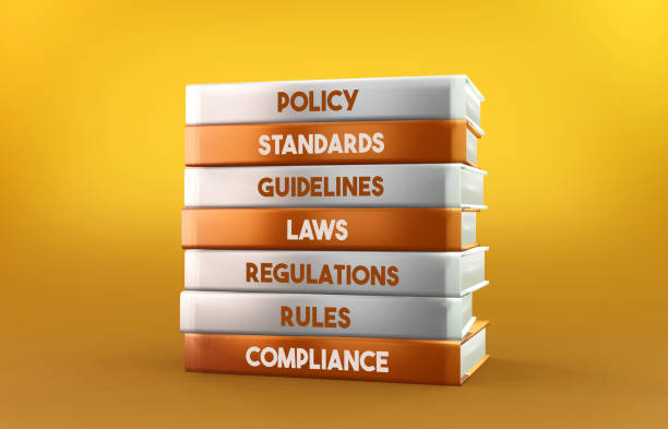 Orange and white Compliance books stand on an orange background stock photo