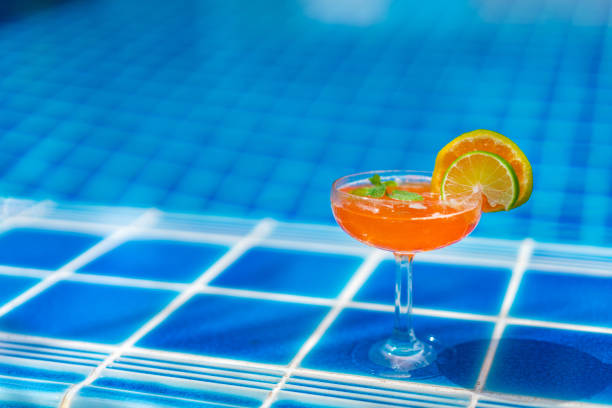 Orange cocktail by the pool with copy space for text stock photo