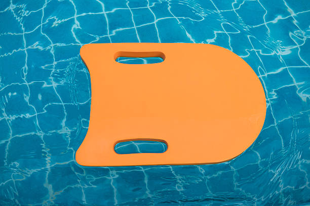 Orange foam board floating in swimming pool Orange foam board floating in swimming pool foamcore stock pictures, royalty-free photos & images