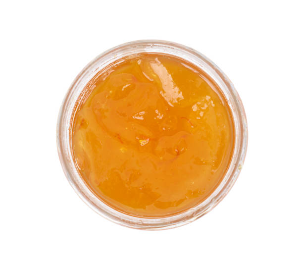 Orange homemade jam isolated on white background. Top view. stock photo