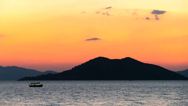Orange Sunset and A Rowboat stock photo